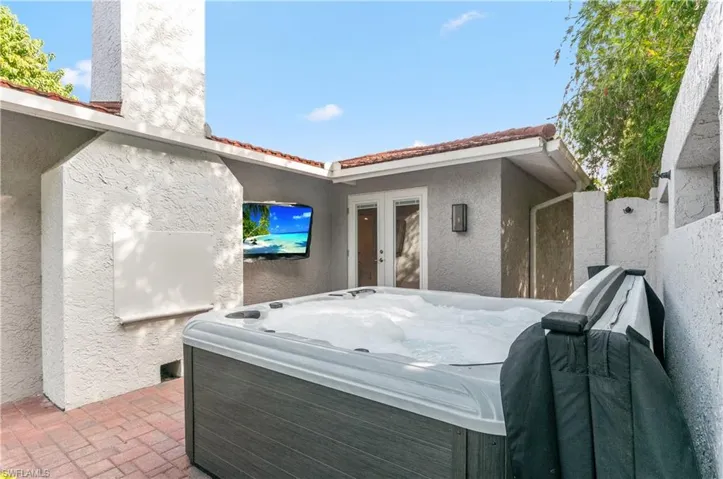 View of patio / terrace with french doors and a hot tub