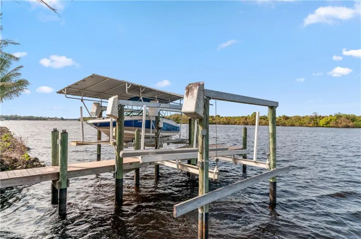Dock area with boat lift and a water view