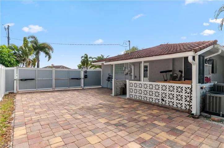 View of patio featuring a gate