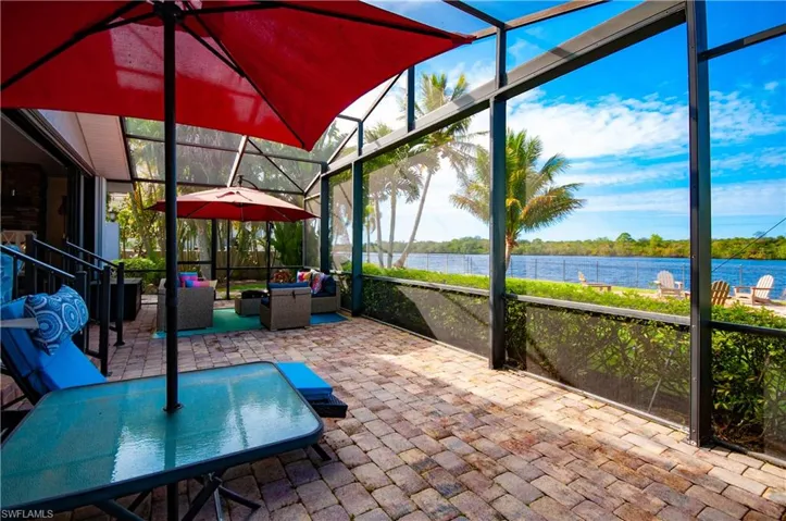 Unfurnished sunroom featuring an outdoor living space, a water view, a patio, and outdoor dining area