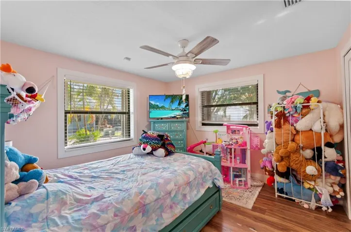 Bedroom with wood finished floors and a ceiling fan