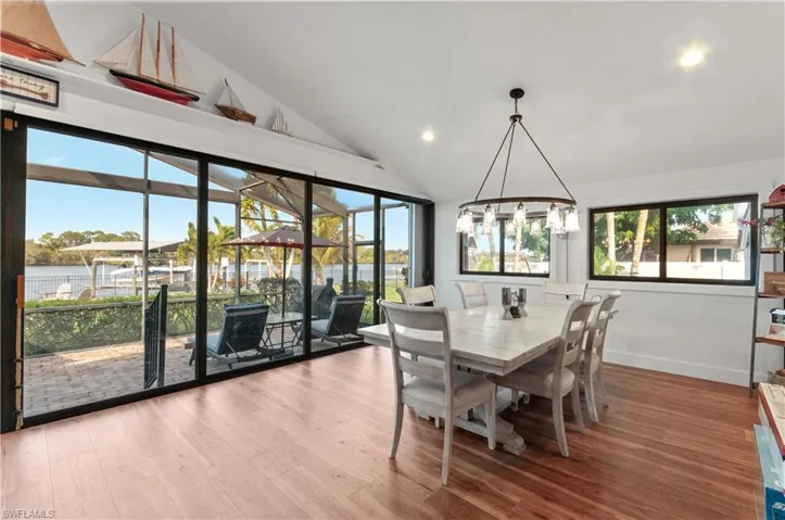 Dining area with light wood-type flooring, lofted ceiling, and recessed lighting