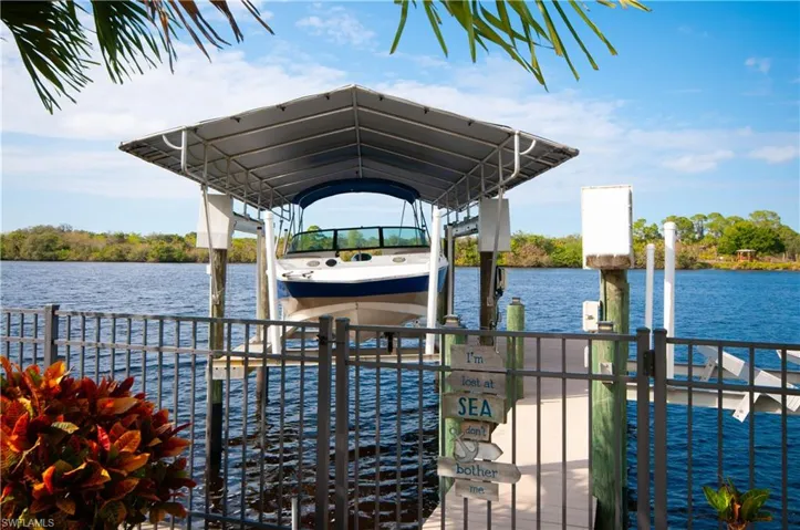 Dock area with boat lift and a water view