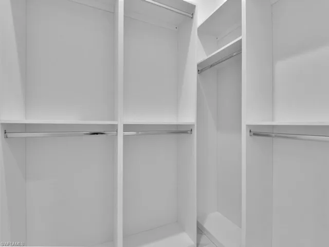 View of spacious closet in the primary bedroom.