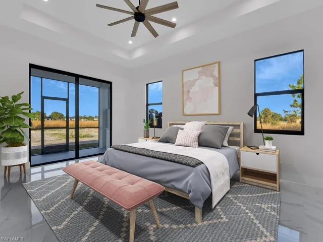 Primary Bedroom featuring access to the screened lanai , a raised ceiling, and ceiling fan. Furnitures are not included.