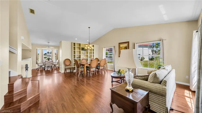 Lots of Natural Lighting ~ Living Room with wood-type floors, vaulted ceiling