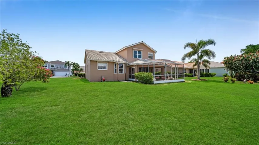 Rear view of house with beautiful yard, Screened oversized covered lanai