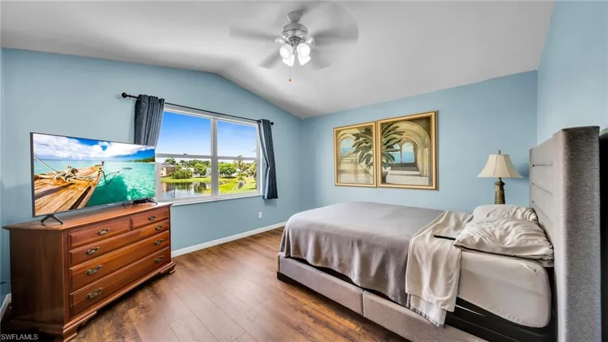 Master Bedroom with wood-style flooring, lofted ceiling, and a Big Lake View