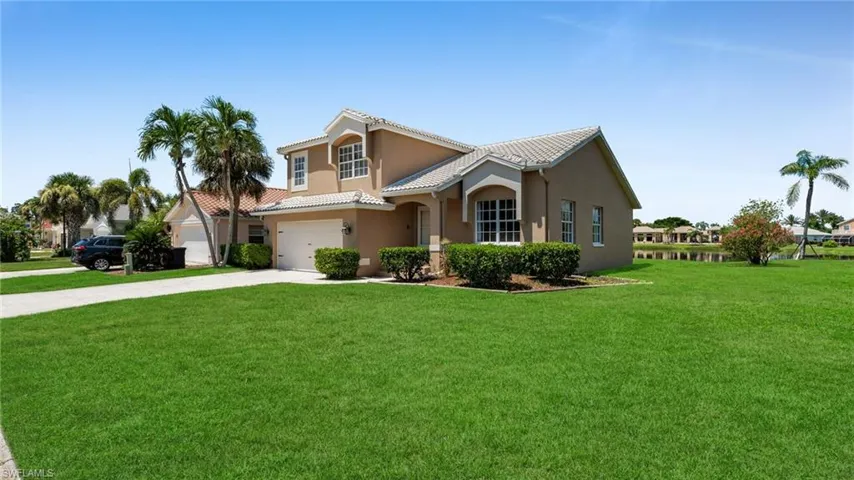 View of front facade featuring concrete driveway, a front yard, stucco siding, and an attached garage