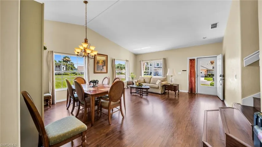 Formal Dining View leading into Formal Living Room, wood-type flooring, and vaulted ceiling