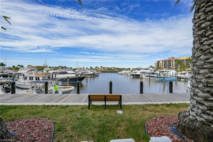 Dock with a water view and a yard