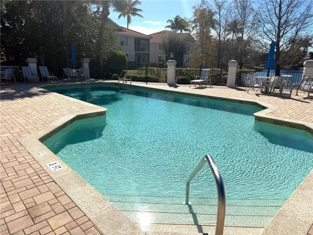 Larger Community pool with a patio