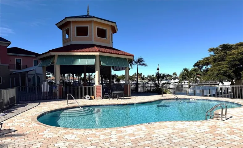 Community pool featuring a patio area and a gazebo