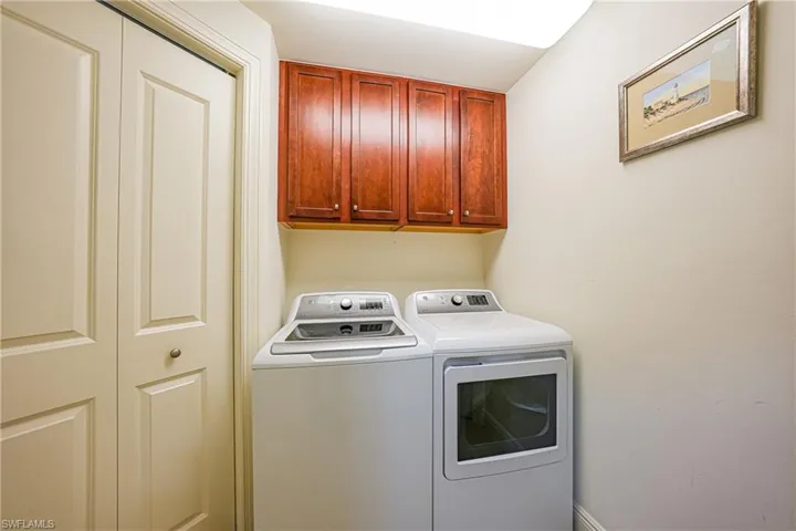 Laundry room featuring cabinet space and washing machine and clothes dryer