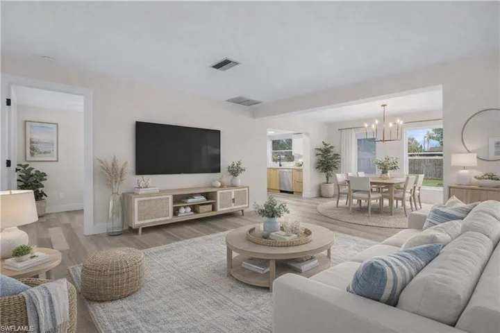 Living area featuring wood look vinyl floors. (virtually Staged)