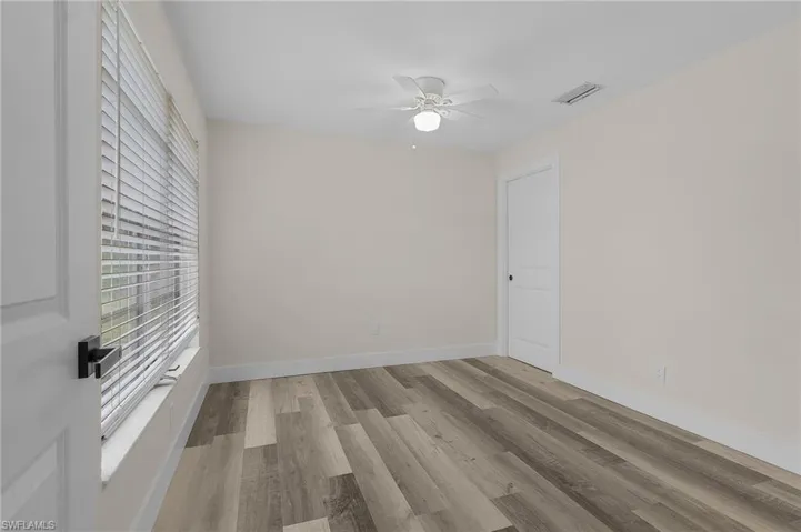 Unfurnished room with ceiling fan and light hardwood / wood-style flooring