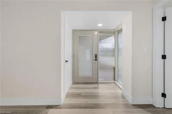Hall with light hardwood / wood-style flooring
