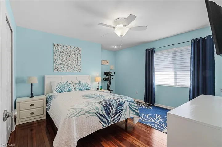 Guest bedroom one with beautiful hardwood floors