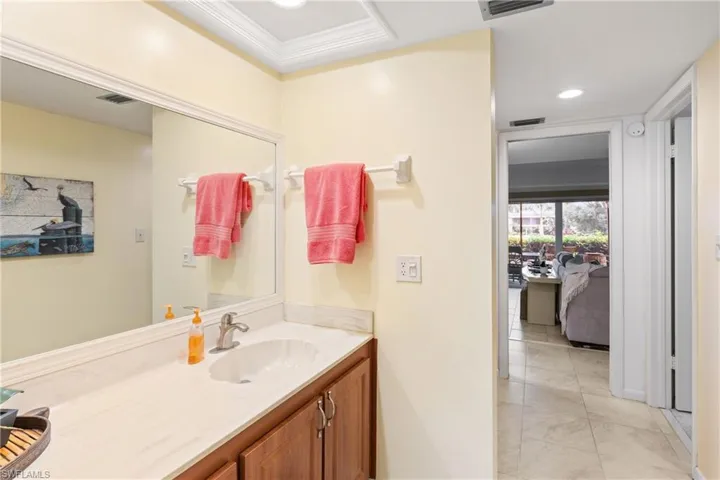 Bathroom featuring vanity and crown molding