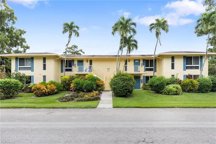 Split foyer home with a balcony and a front yard