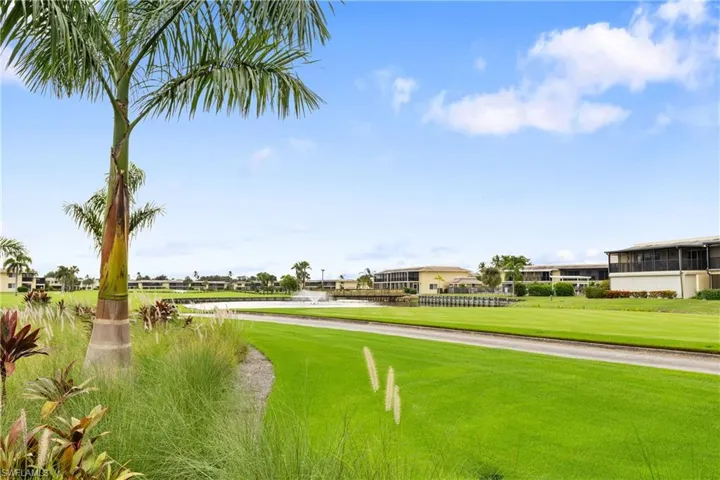 View of property's community with a lawn