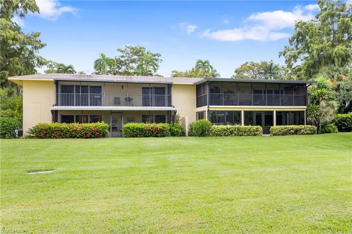 View of front facade with a sunroom and a front lawn
