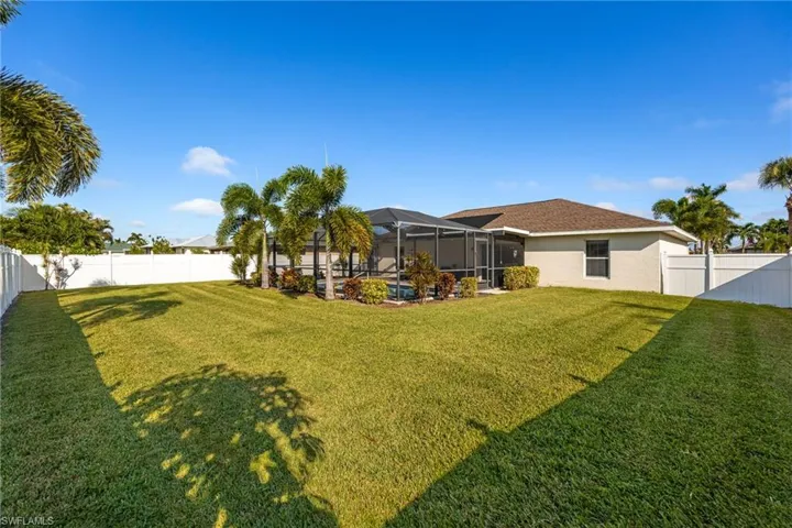 Fenced backyard featuring a lanai and a sunroom