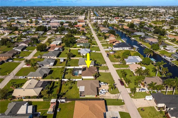 Aerial overview of property's location with nearby suburban area and a large body of water