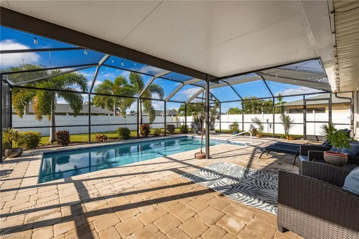 View of pool with a patio, a sunroom, glass enclosure, and a fenced backyard