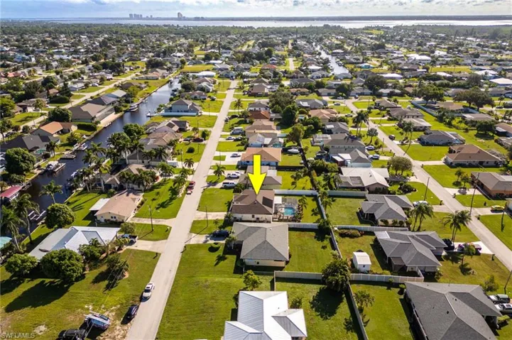 Aerial overview of property's location with a large body of water and nearby suburban area