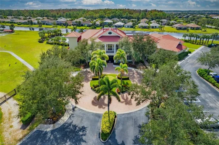 Birds eye view of property with a water view