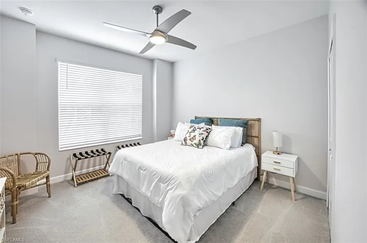 Carpeted bedroom with ceiling fan