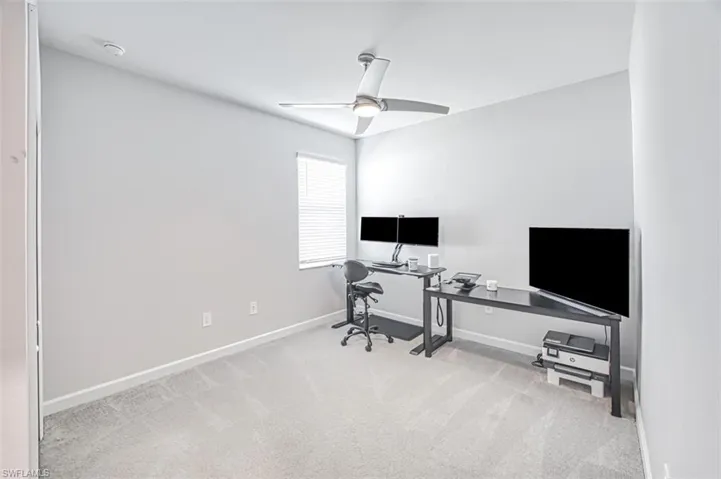 Office featuring light carpet and ceiling fan