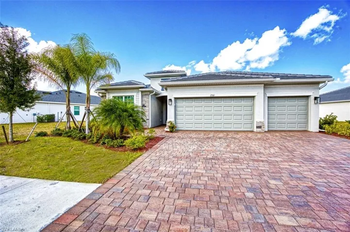 View of front of property featuring a front yard and a garage