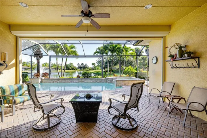 Lanai with pavers overlooking lake and fountain