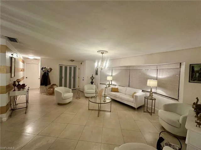 Spacious room featuring neutral-toned square tile flooring throughout