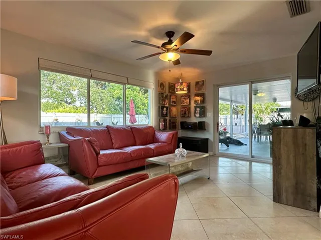 Living area with tiled flooring and a ceiling fan