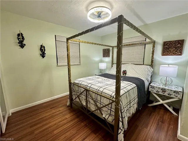 Warm-toned wood-finish flooring complements light green walls