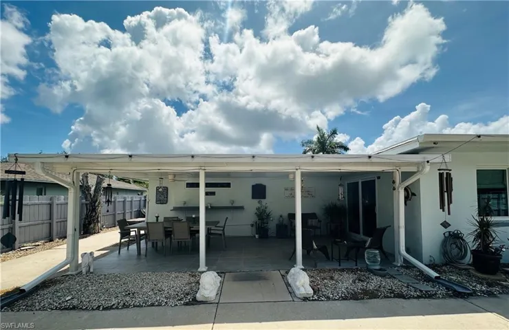 Covered patio area featuring a white metal roof structure