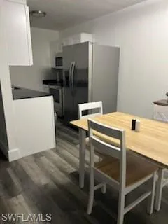 Dining room with dark wood-style floors