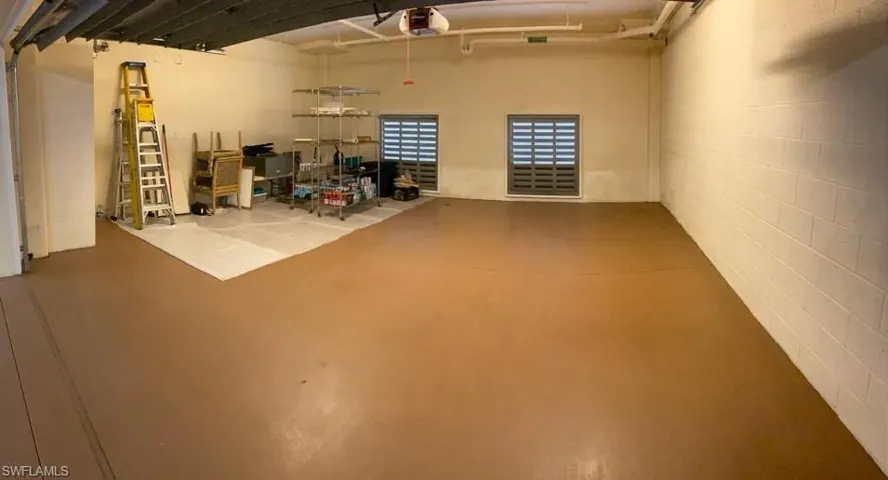 Garage with air conditioning and a garage door opener