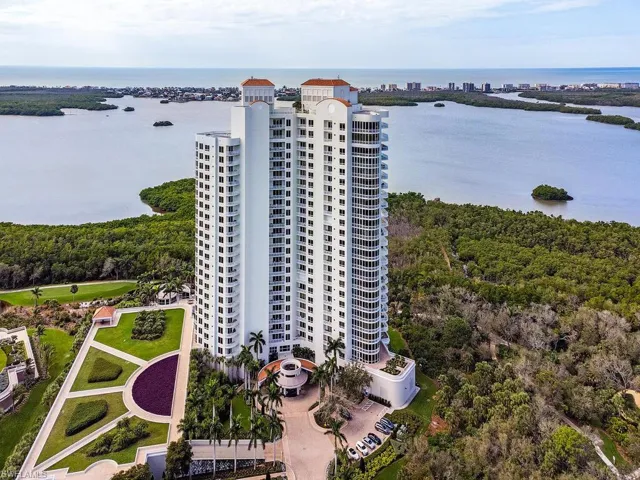 Aerial view of a large body of water and apartment complex / building