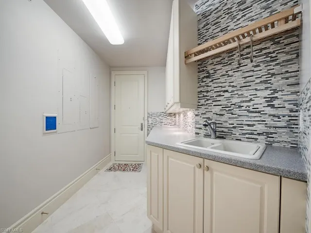 Washroom featuring baseboards and electric panel