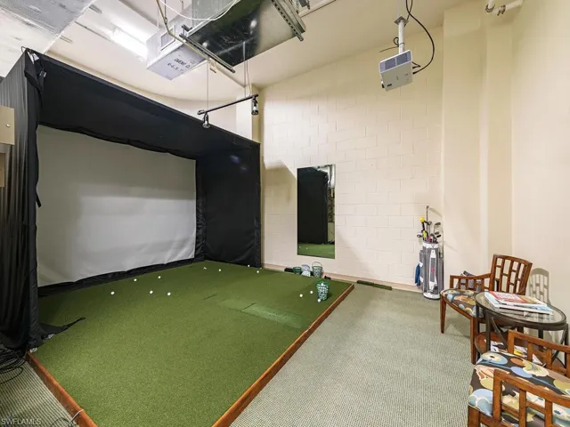 Rec room with golf simulator and carpet