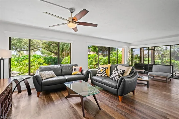 Living area featuring wood finished floors and a ceiling fan