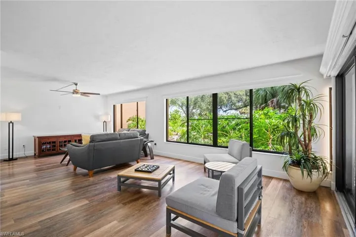 Living area with wood finished floors and a ceiling fan