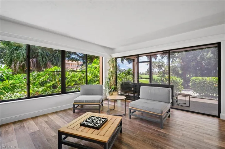 Sunroom featuring plenty of natural light and wood finished floors