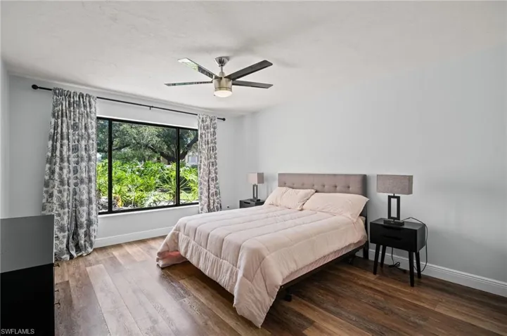 Bedroom with hardwood / wood-style flooring and ceiling fan