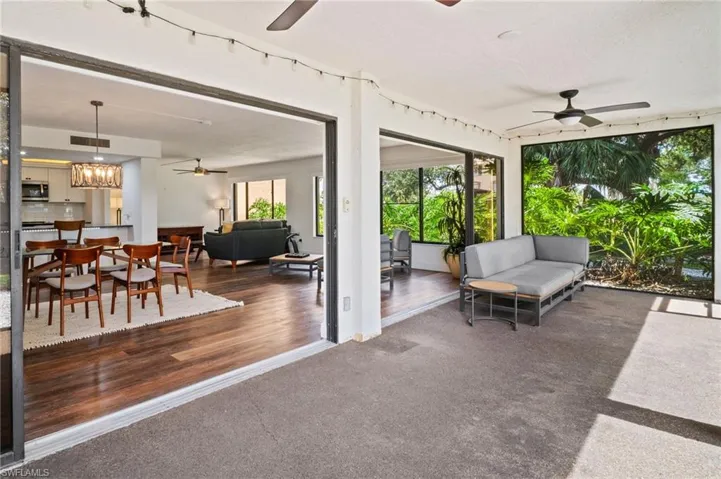 View of patio with ceiling fan, an outdoor hangout area, and a sunroom