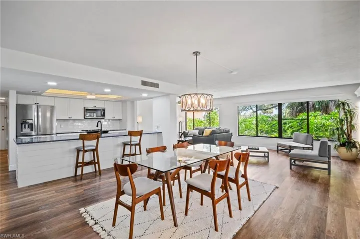 Dining area featuring a chandelier and dark wood finished floors